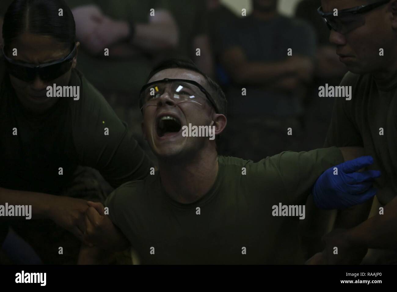 Us Marine Corps 2. Lt. Michael Enomoto, Militär, Polizei, Zeitformen und schreit, nachdem mit Taser Widerhaken als Teil der Non-Lethal Waffen Instructor Kurs auf Camp Hansen, Okinawa, Japan. Marines, Matrosen, Flieger und Japanische Sicherheitsbeamte abgeschlossen eine Woche lang Non-Lethal Waffen Instructor Kurs, der Taser Ausbildung, OC Belichtung und riot control Team Taktik. Stockfoto