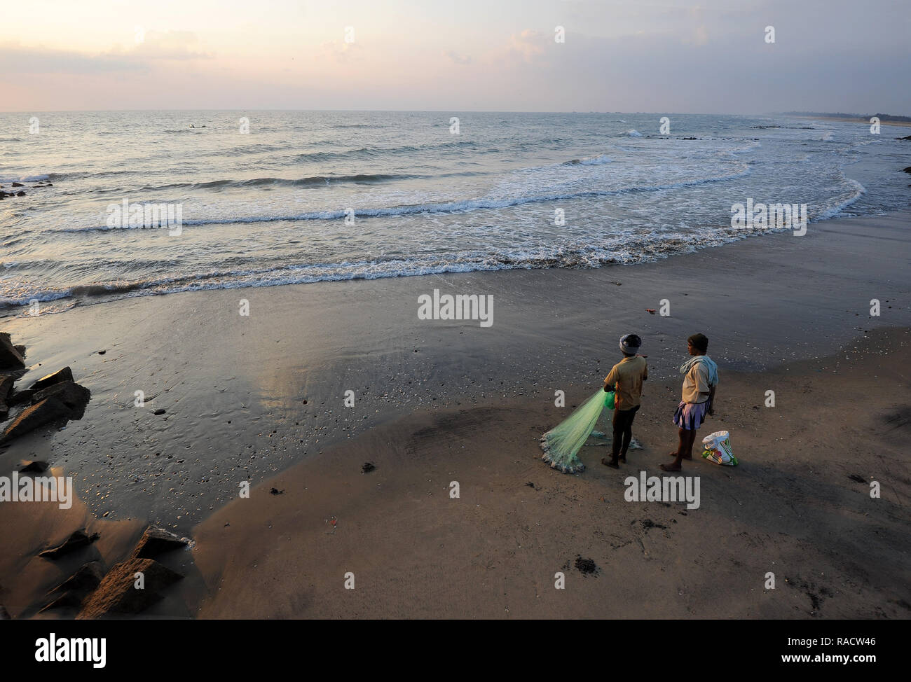 Fischer Vorbereitung Fischernetz bei Sonnenaufgang in den Gewässern der Bucht von Bengalen, Tranquebar, Tamil Nadu, Indien, Asien zu werfen Stockfoto