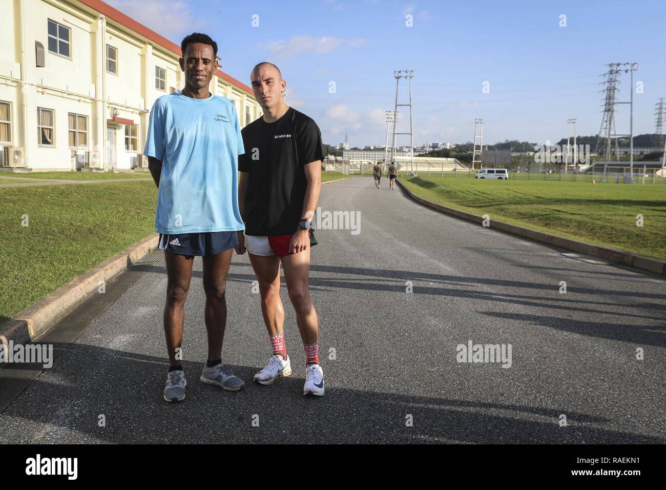 U.S. Navy Petty Officer 1st Class (PO1) Wosense Tesfaye, eine Apotheke Techniker mit United States Naval Hospital Okinawa, (links) und 1 Lieutenant (1. Lt) Payton Nevills, (rechts) posieren für ein Foto Nach den fünf Kilometer (5 K) Rennen auf dem Jingle Bell Herausforderung auf Camp Foster, Okinawa, Japan, Dez. 14, 2018. PO1 Tesfaye beendete im ersten Platz und 1 Lt Nevills wurde Zweiter. Die Herausforderung war der Zusammenhalt zwischen Navy und Marine Corps Einheiten an Bord MCB Camp Butler, der durch die Teilnahme an verschiedenen Wettbewerben wie Reifen spiegeln fördern, eine 5K laufen, und Munition können Aufzüge. Stockfoto