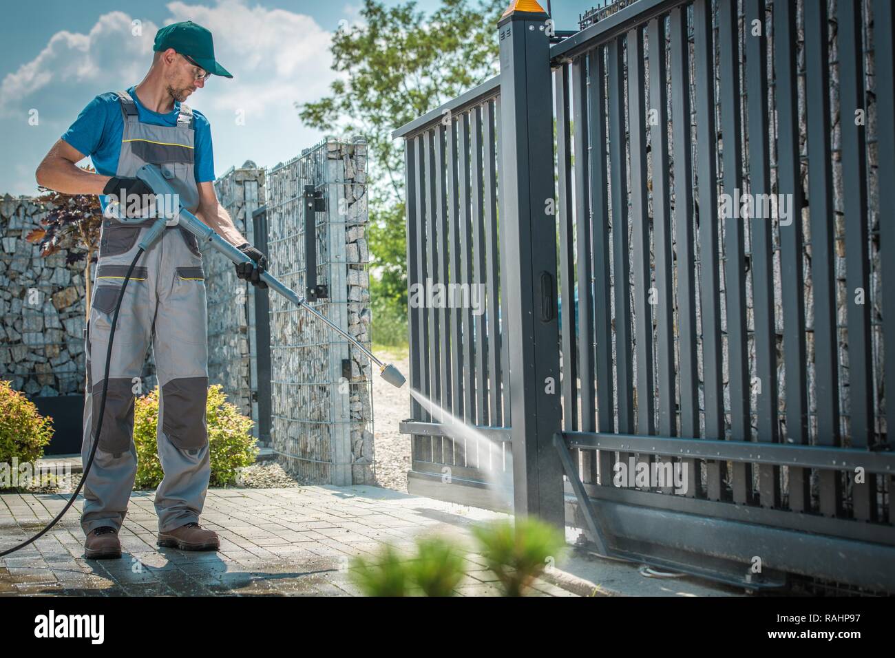 Haus Einfahrt und das Tor Waschen unter Druck durch die kaukasischen Männern Stockfoto