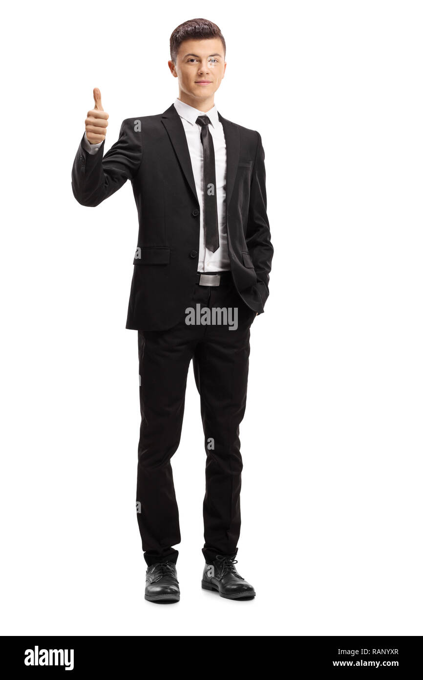 In voller Länge Porträt eines jungen männlichen Erwachsenen in einem eleganten Anzug geben Daumen bis isoliert auf weißem Hintergrund Stockfoto