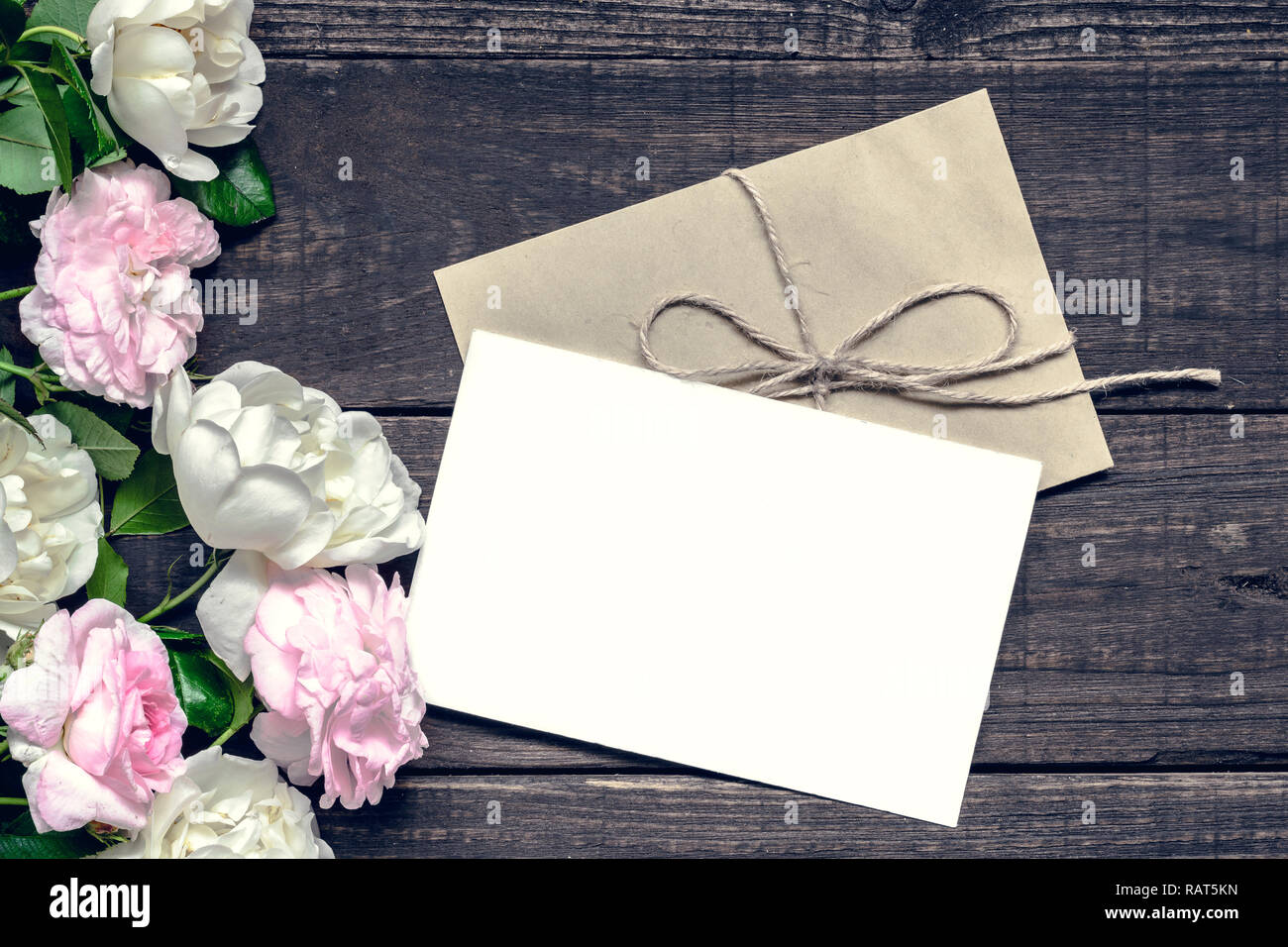 Stilvolle branding Mockup ihre Kunstwerke anzuzeigen. vintage Hochzeit Grußkarte mit rosa und weißen Rosen mock up auf hölzernen Hintergrund. Mütter backgr Stockfoto