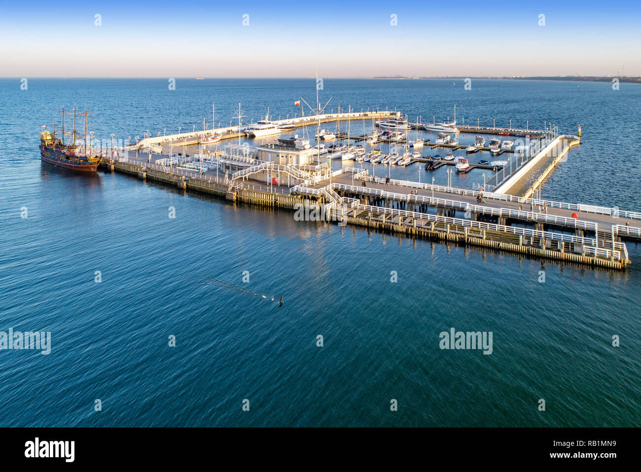 Hölzerne Seebrücke, genannt Molo, mit Hafen, Pirate touristische Schiff und Hafen mit Yachten in Sopot Resort in der Nähe von Danzig in Polen im Abendlicht. Luftaufnahme Stockfoto