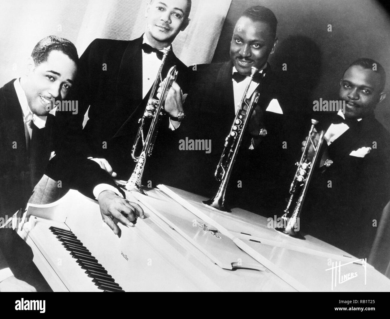 Porträt der amerikanischen Jazzmusiker Duke Ellington an einer weißen Piano mit drei seiner Bläser (L-R): Artie Whetsol, Cootie Williams und Rex Stewart. 1940. Stockfoto