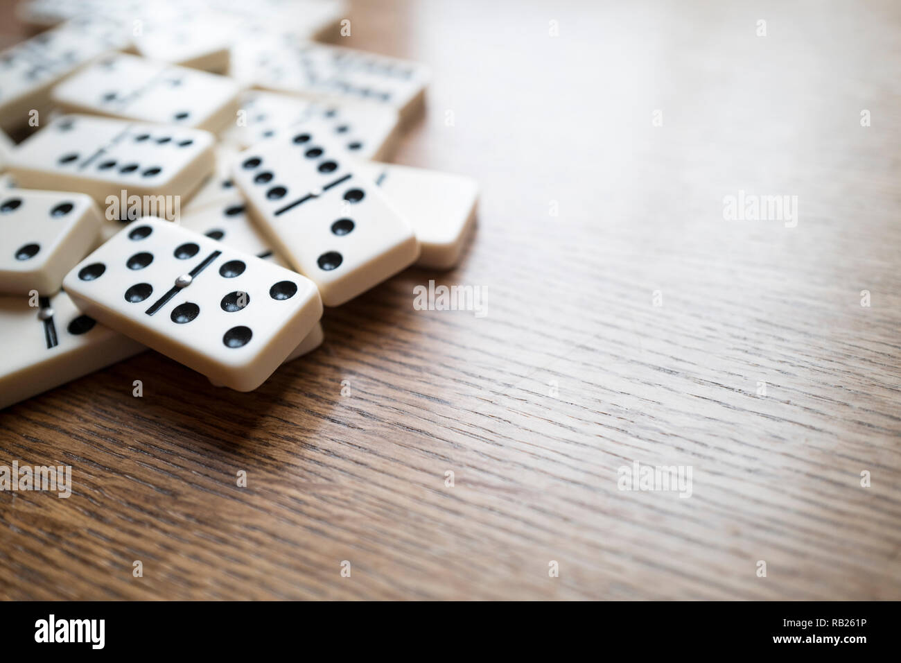 Horizontales Bild der Domino auf einem Holztisch, Bild horizontal mit leeren Raum auf der rechten Seite Stockfoto