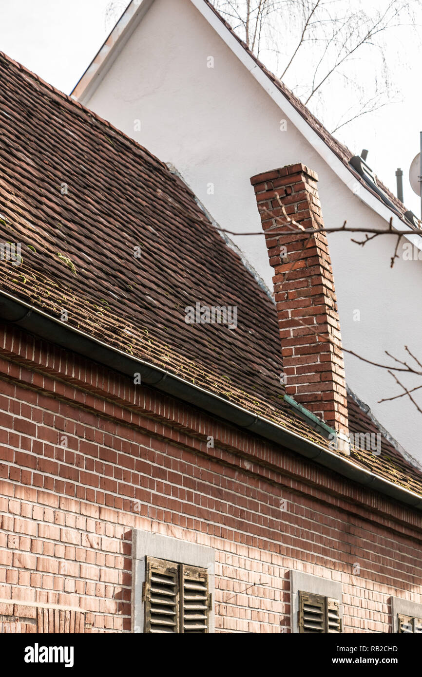 Alte, leere Backsteinhaus mit krummen Schornstein Stockfoto