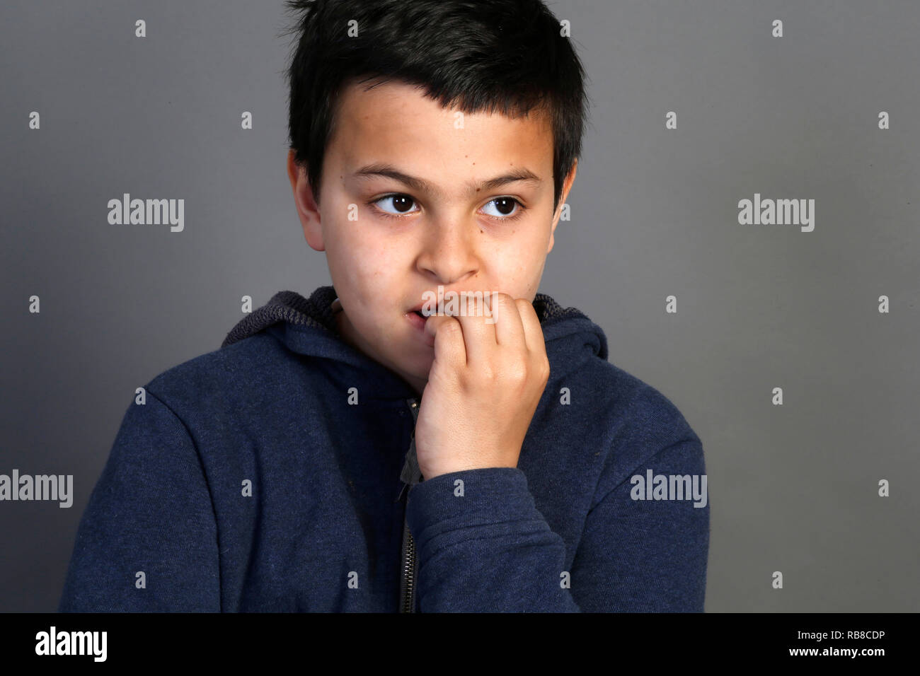 12-jähriger Junge Beißen seiner Nägel. Paris, Frankreich. Stockfoto