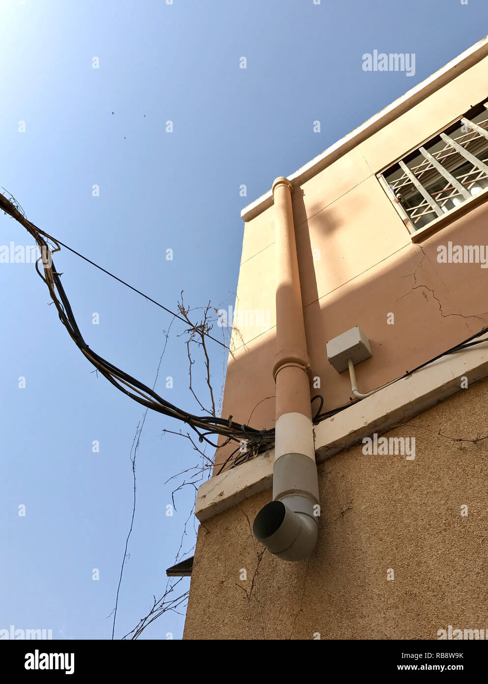 Sonne scheint die elektrischen Kabel, Anschluss an der Außenseite der Wand des Hauses Stockfoto