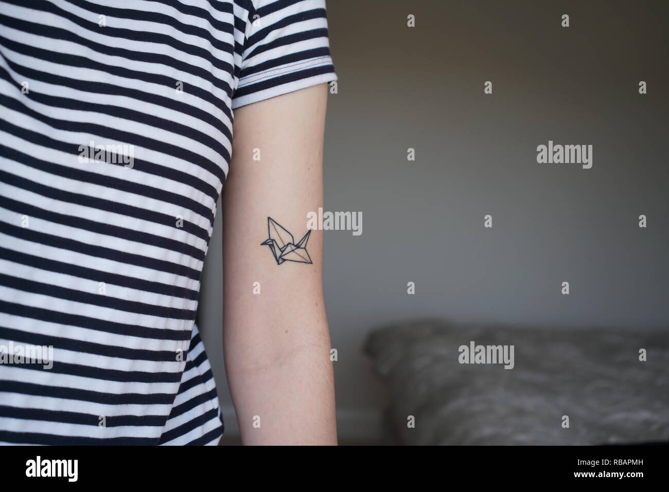 Origami crane tattoo Stockfoto