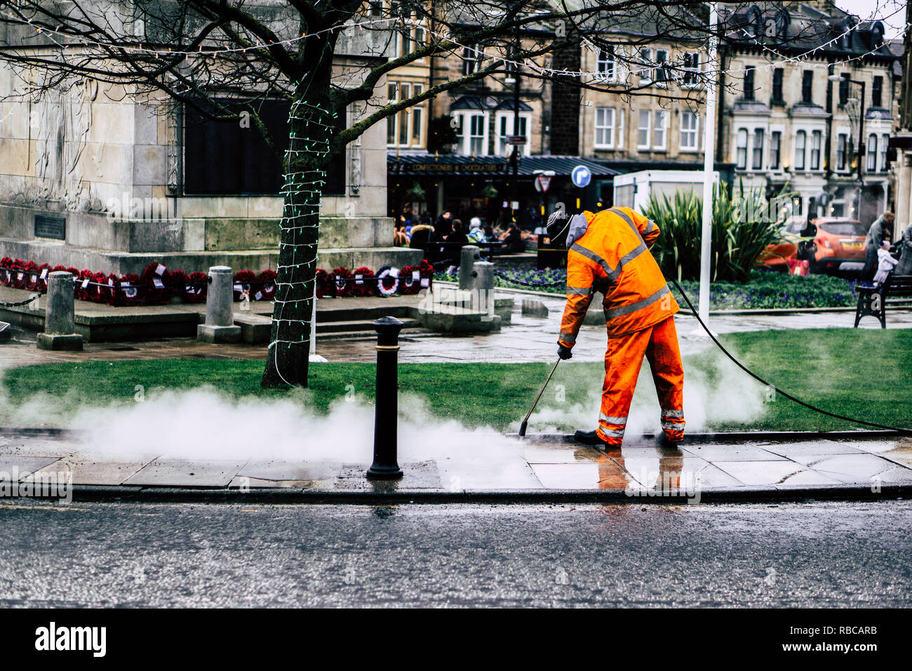 Ein Arbeiter mit Hochdruckreinigern das Pflaster auf einer Straße in Yorkshire. Stockfoto