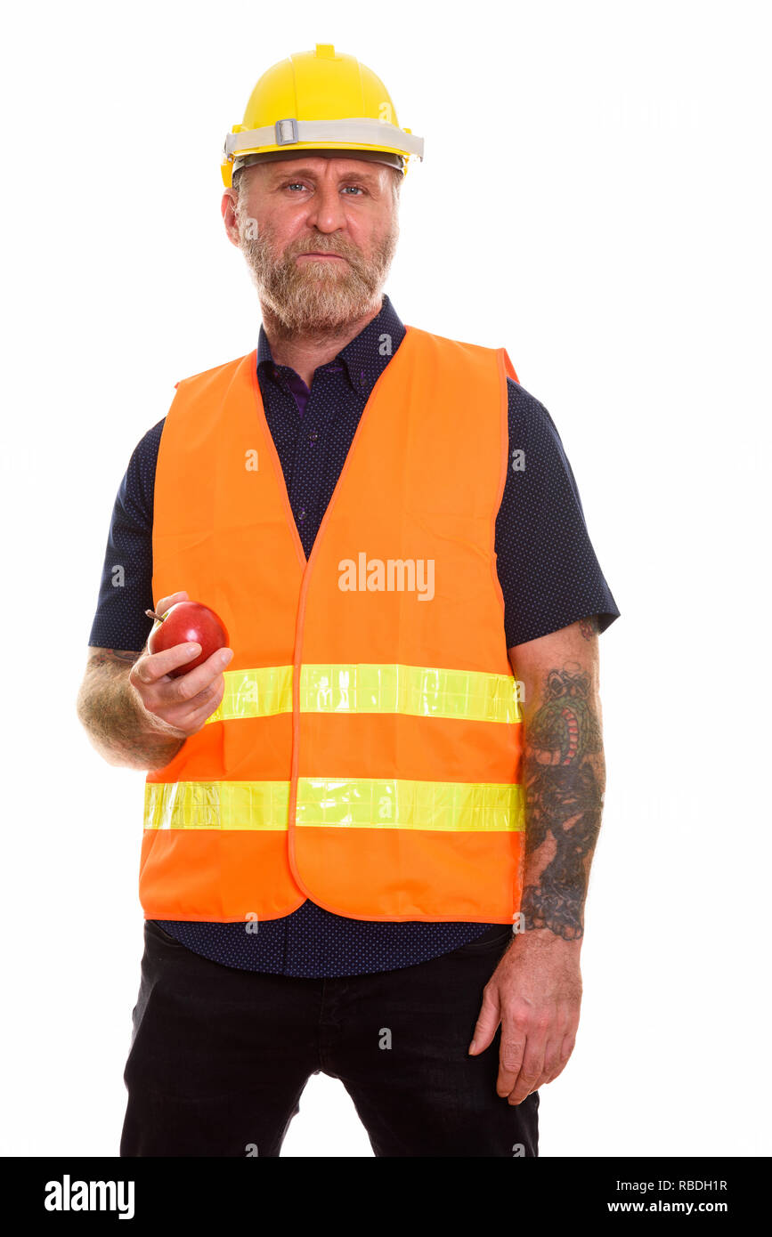 Reife bärtige Mann Bauarbeiter mit Apfel Stockfoto