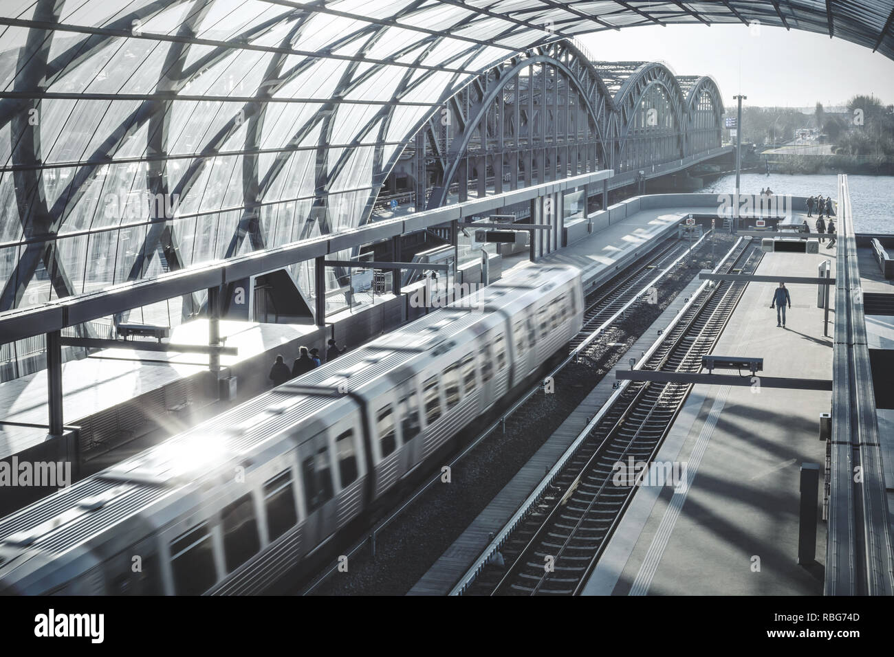 Blick von oben auf einen Zug bei einem modernen Bahnhof ankommen Stockfoto