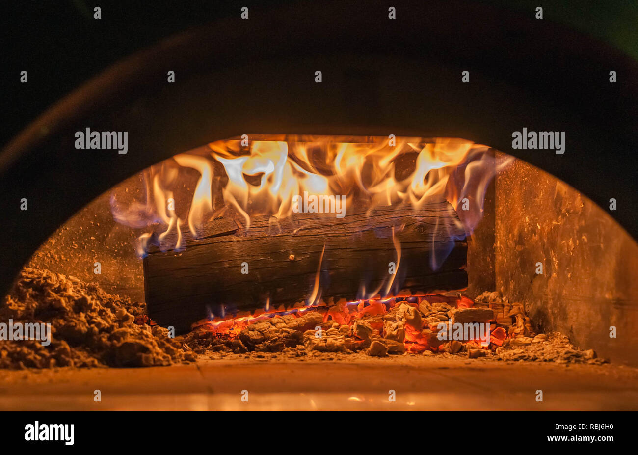 Holz brennt in Pizza Ofen in der Nähe von Flammen und brennenden Glut Stockfoto