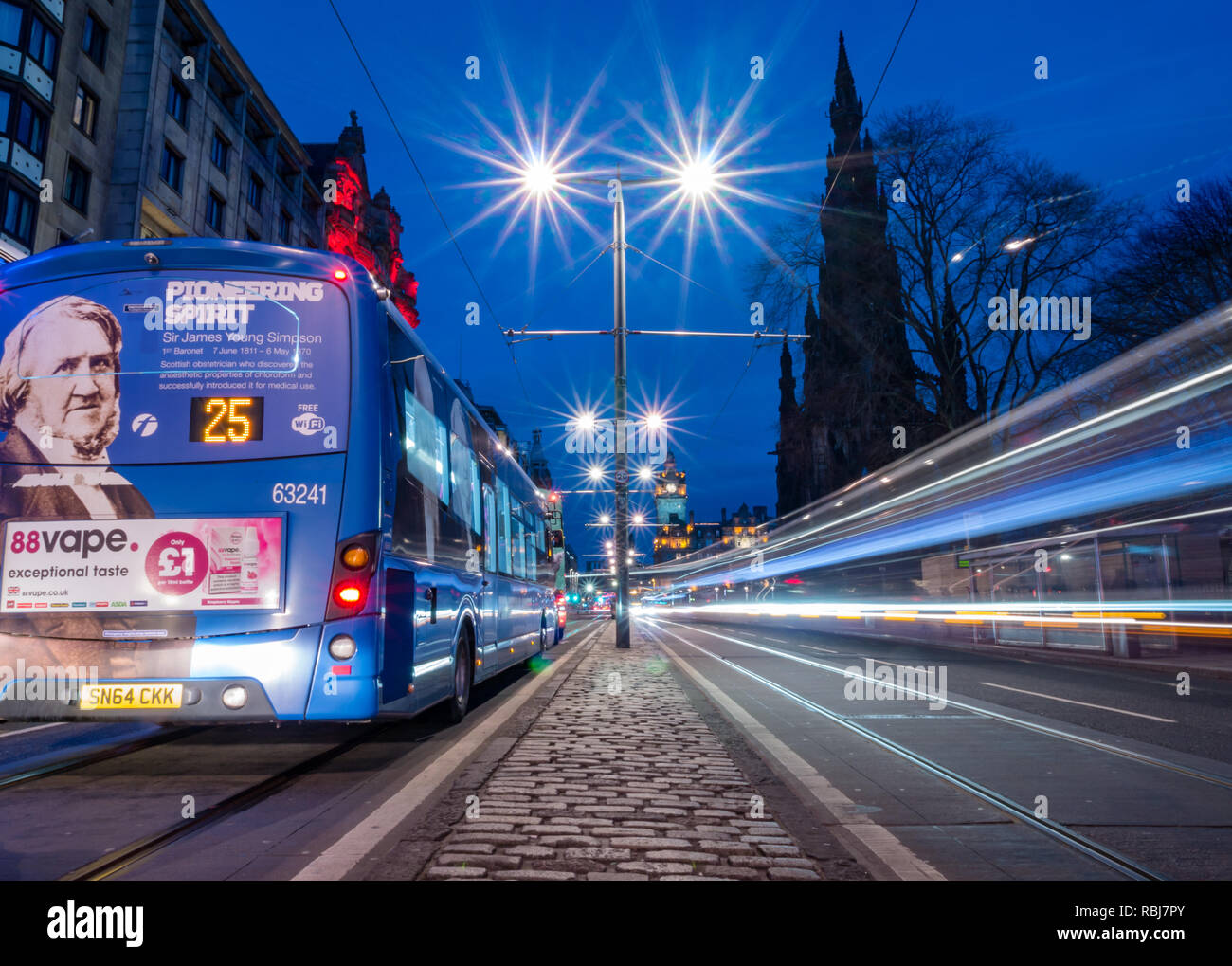 Nacht Spuren von Bussen und Straßenbahnen, die Princes Street, mit Balmoral Wecker und Scott Monument, Edinburgh, Schottland, Großbritannien Stockfoto