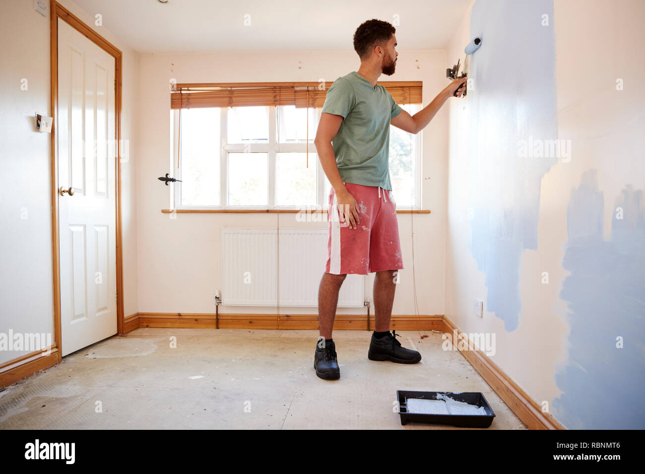 Man dekorieren Zimmer im neuen Haus Malerei Wand Stockfoto