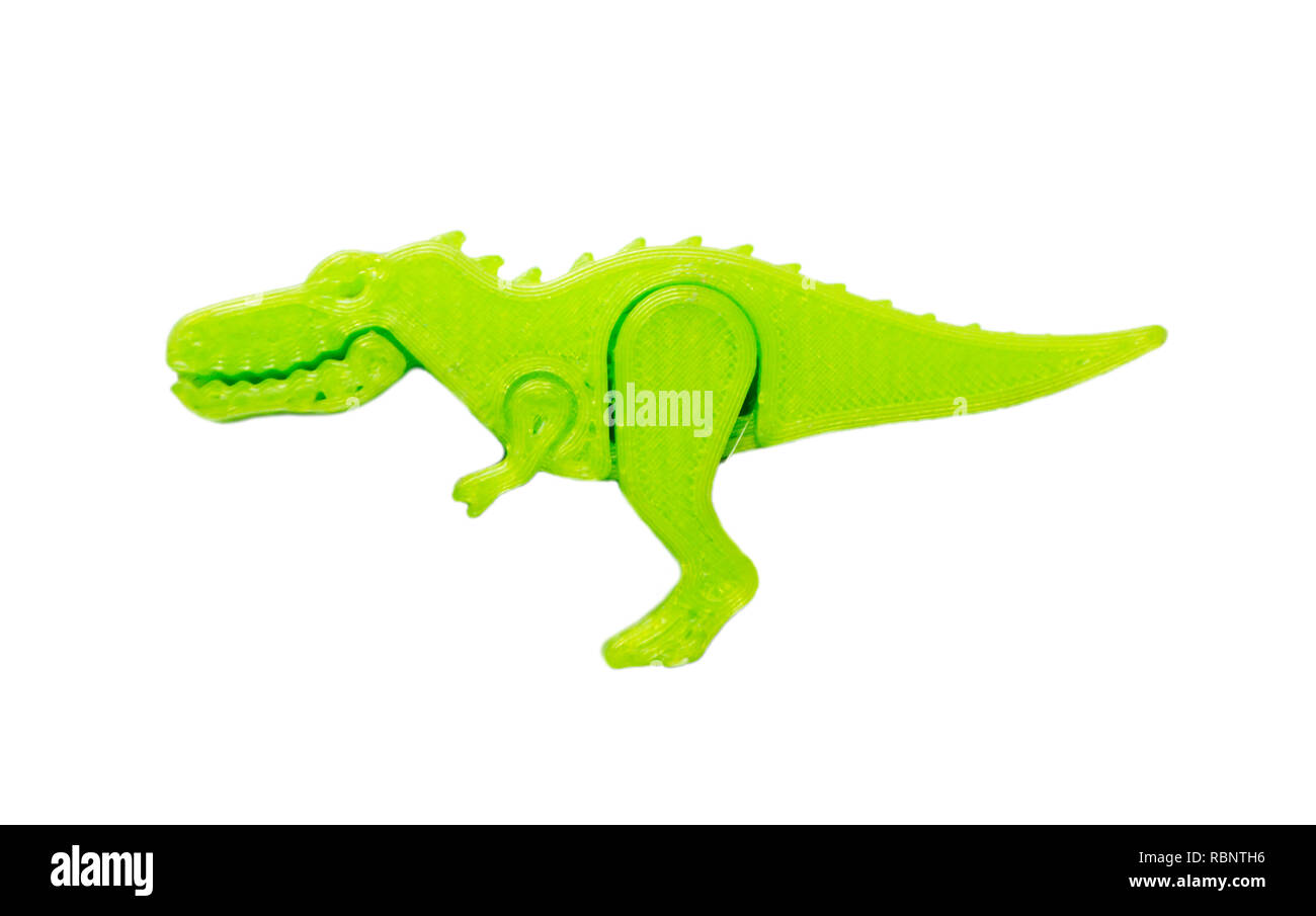 Helles Licht grünes Objekt in Form von Dinosaurier Spielzeug auf 3d Drucker auf weißem Hintergrund gedruckt. Fused Deposition Modeling, FDM. Konzept moderne progressive Additiv Technologie für 3D-Druck. Stockfoto