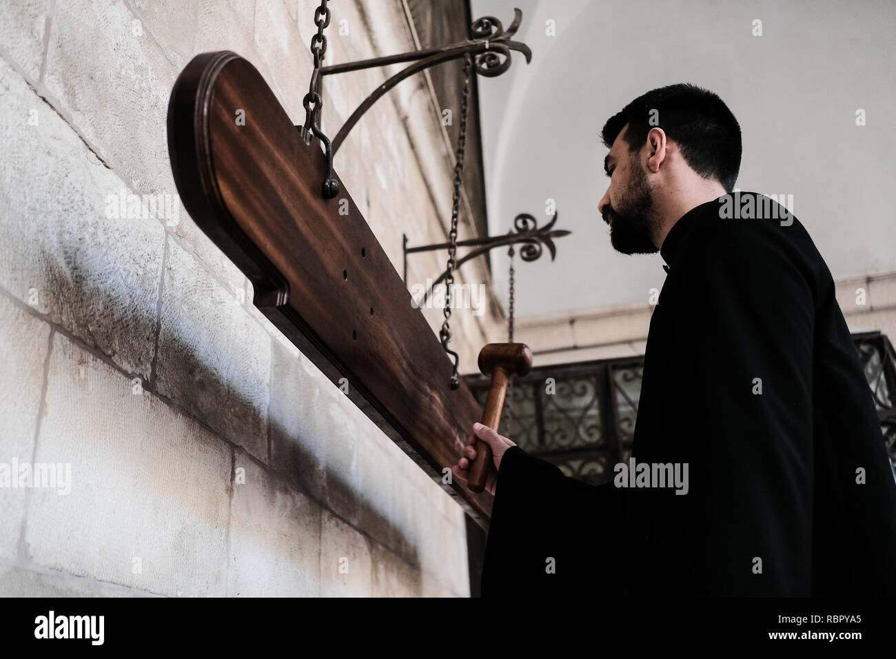 Eine Priesterschaft Seminarist Streiks Nakos oder simandron, Holzplatten statt der Glocken wird verwendet, wenn der osmanischen Herrscher das Läuten der Kirchenglocken verbot, t Stockfoto