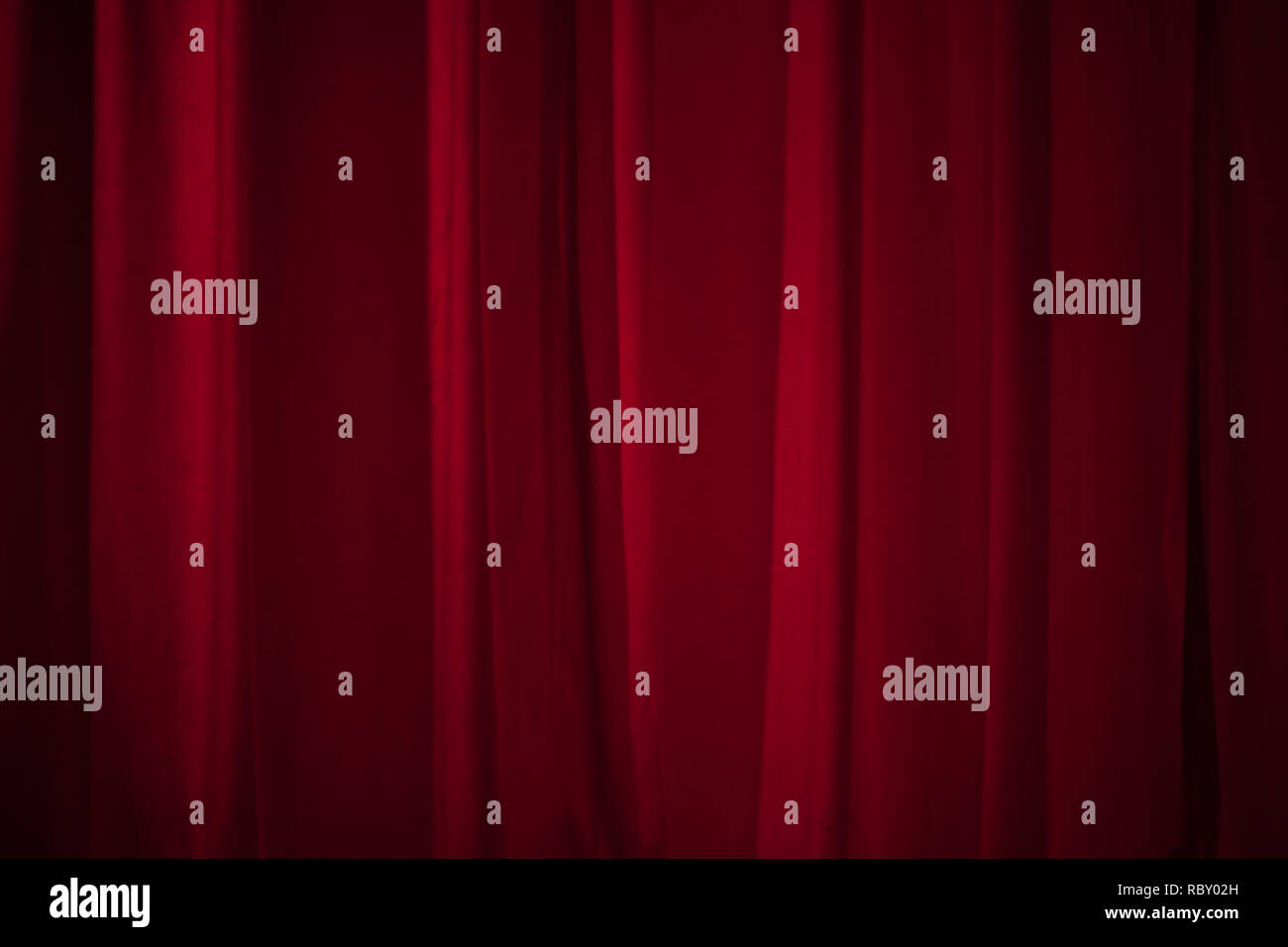 Rote Vorhang Kulisse auf der Bühne mit dezenter Beleuchtung. Stockfoto