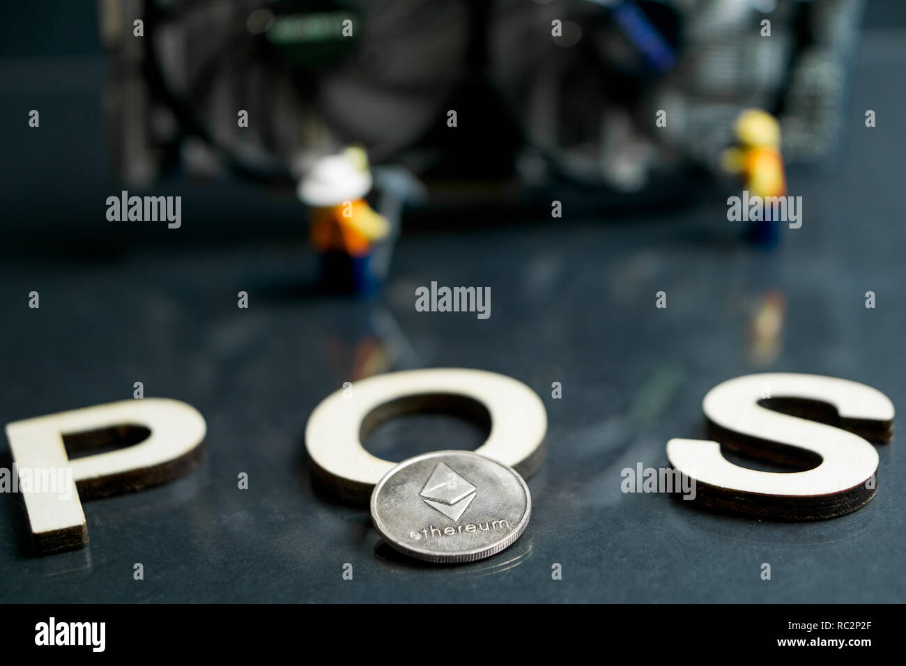 Des astraleums Cryptocurrency Umschalten von POW, GPU Bergbau, POS, POS-Schild mit Grafikkarte und Figuren im Hintergrund Stockfoto