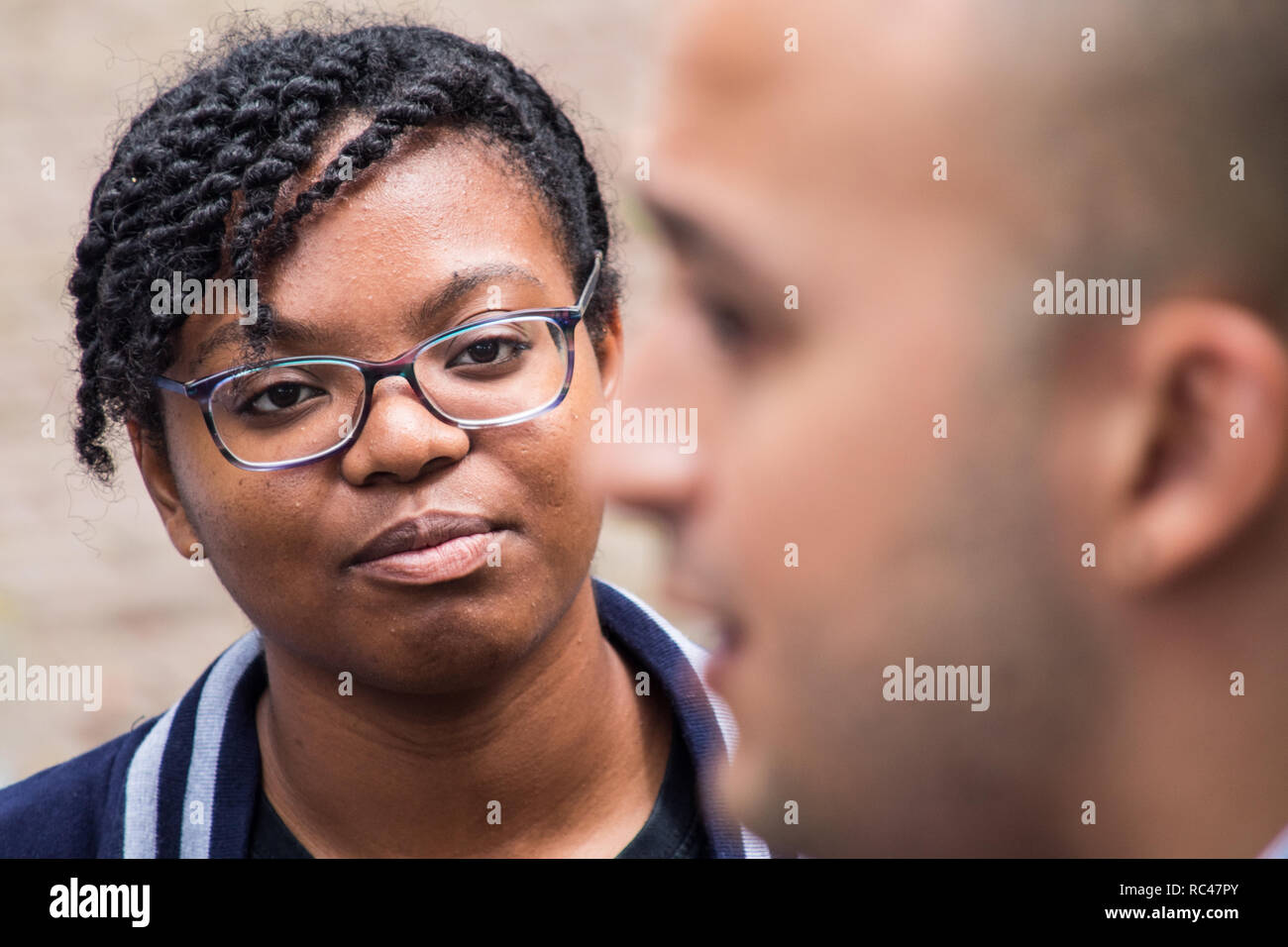 Das Porträt einer wunderschönen karibischen Schülerin genau hinzuhören, um Ihren Lehrer Stockfoto