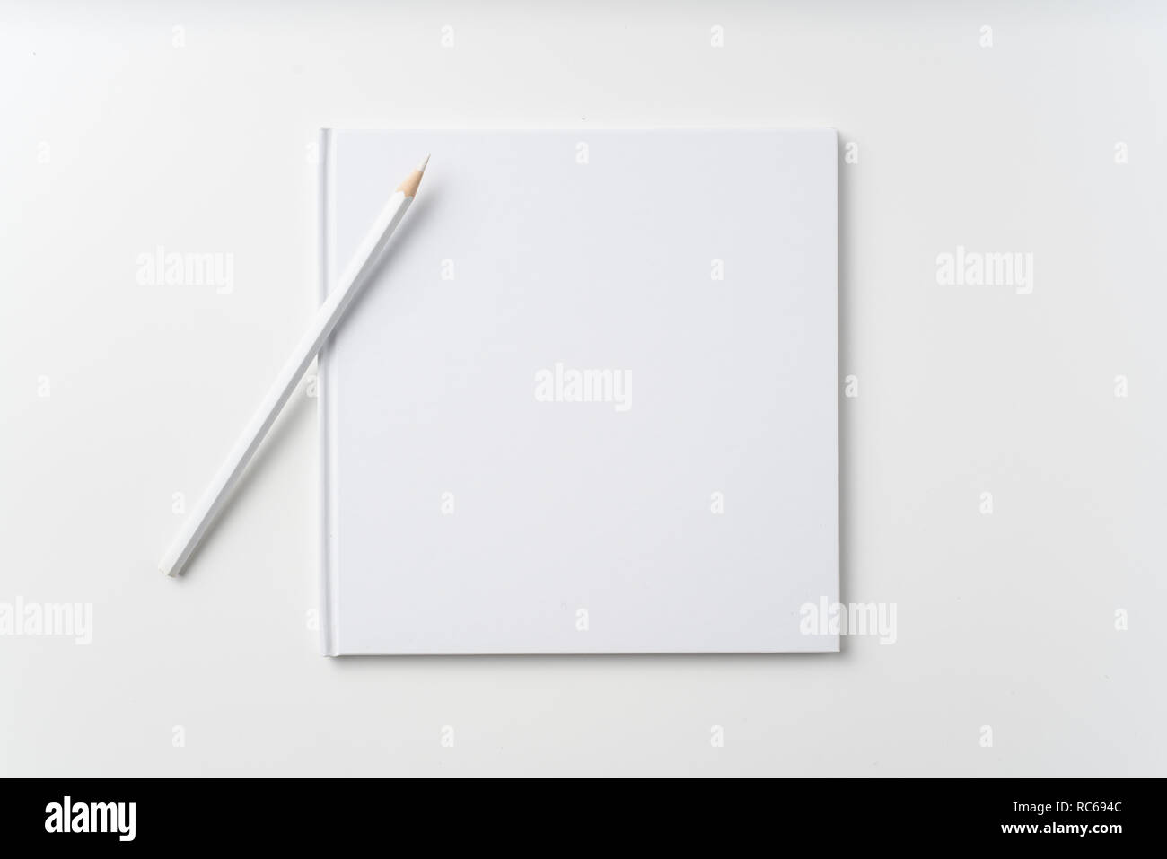 Designkonzept - Blick von Oben auf die reine weiße Notebook, weiße Seite und Bleistift isoliert auf Hintergrund für mockup Stockfoto