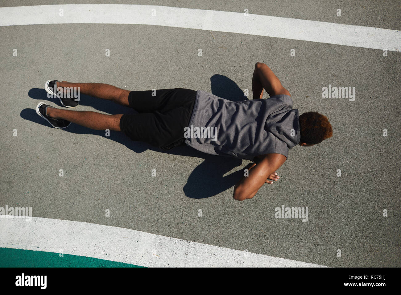 Starke schwarze Mann tun Push-ups auf dem Boden Stockfoto