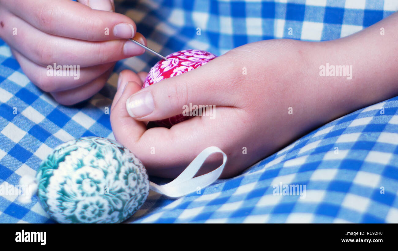 Mädchen Hände detail, die graviert Ostern Ornamente auf farbige Eier, mit Gravur Technik, typische Benutzerdefinierte in Osteuropa Stockfoto