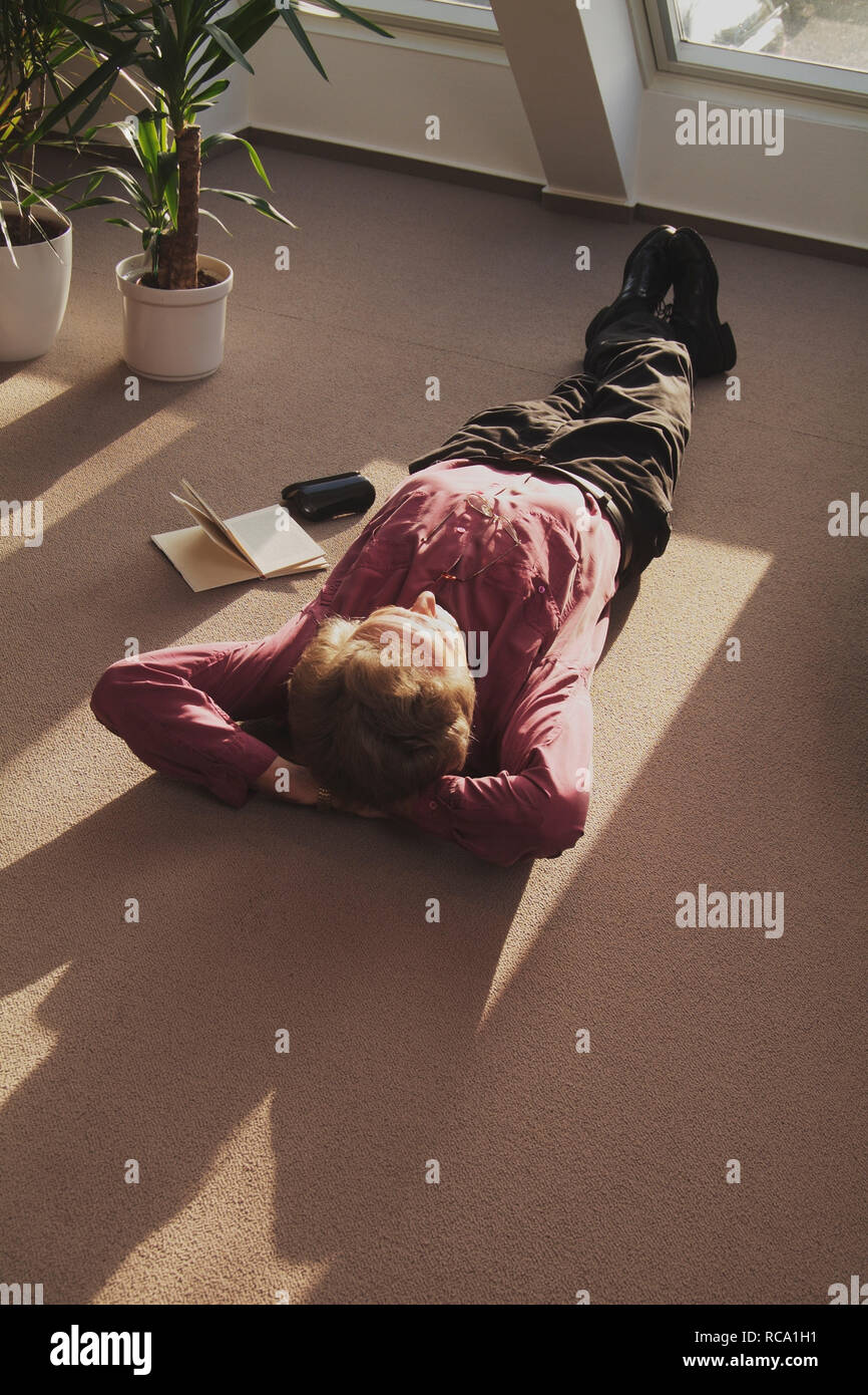 Mann mittleren Ändert Balatonfüred auf dem Boden und entspannt | Mann mittleren Alters ist entspannend auf dem Boden Stockfoto