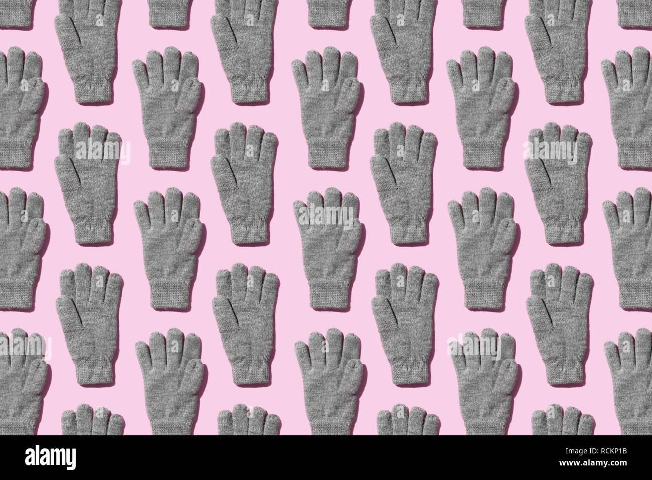 Stricken winter handschuhe über rosa Hintergrund organisiert Stockfoto