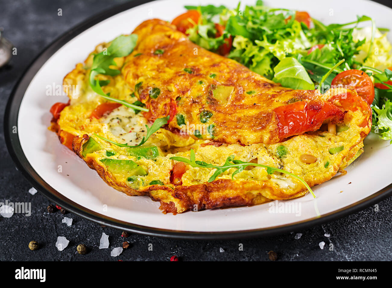 Frühstück. Omelett mit Tomaten, Avocado, Blauschimmelkäse und grünen ...