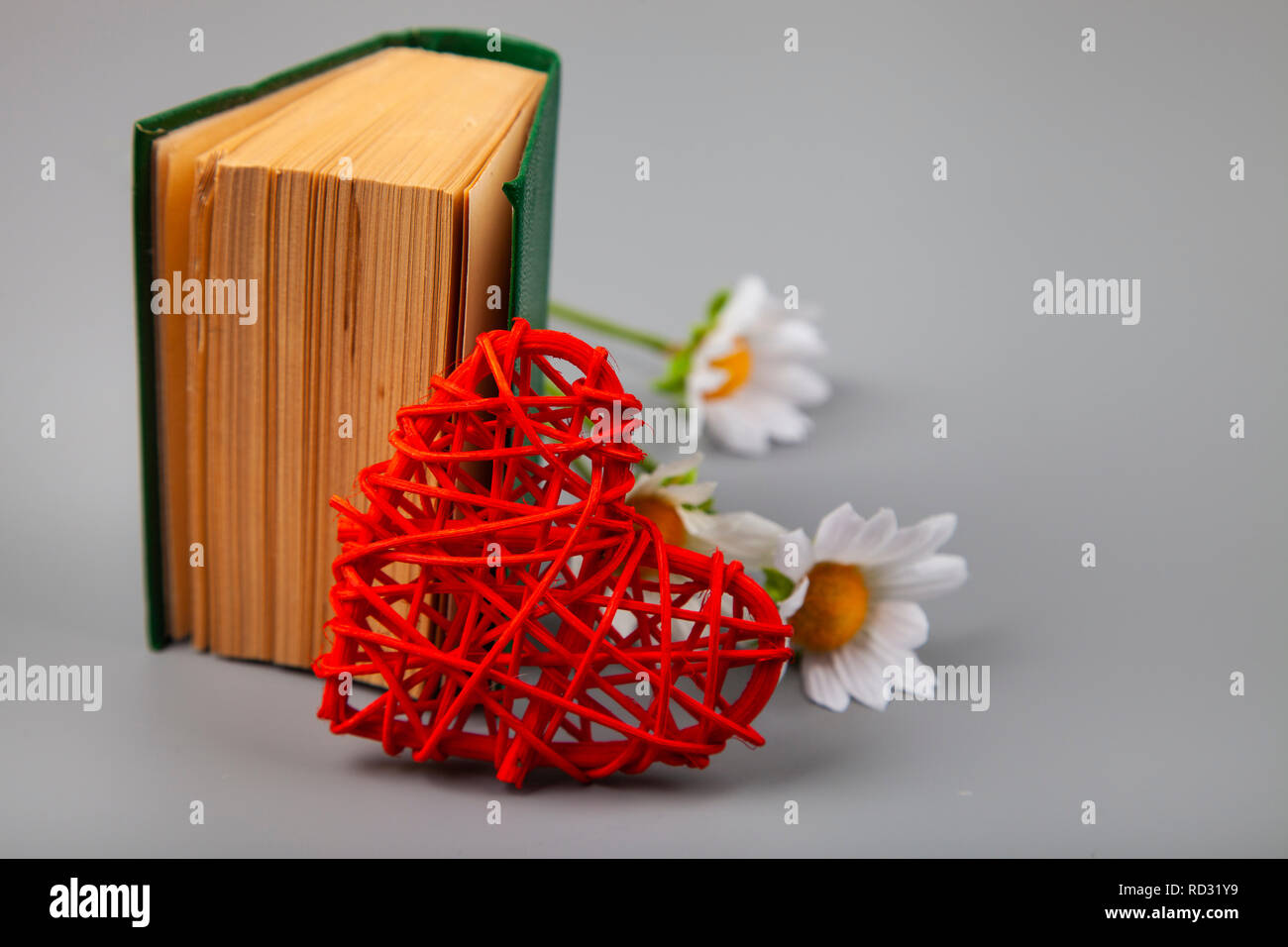 Buchen Sie mit romantischen Gedichten, Blumen und einem Herz. Geschenk für den Valentinstag. Stockfoto