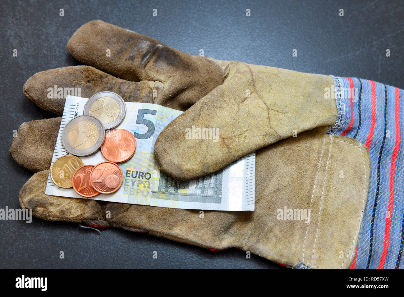 Der Handschuh mit 9,19 Euro Mindestlohn, Arbeitshandschuh mit 9,19 Euro Mindestlohn Stockfoto
