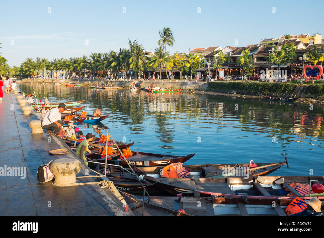 Kleine Boote warten Touristen für Bootsfahrten auf dem Wasserwege rund um die Vietnamesische Stadt Hoi An in Quang Nam Provinz zu nehmen Stockfoto