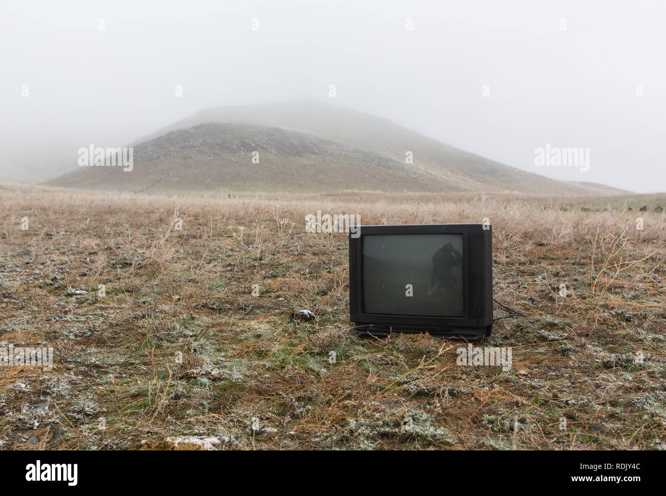 Alte Fernseher stehen auf Heu. Konzeption Stockfoto