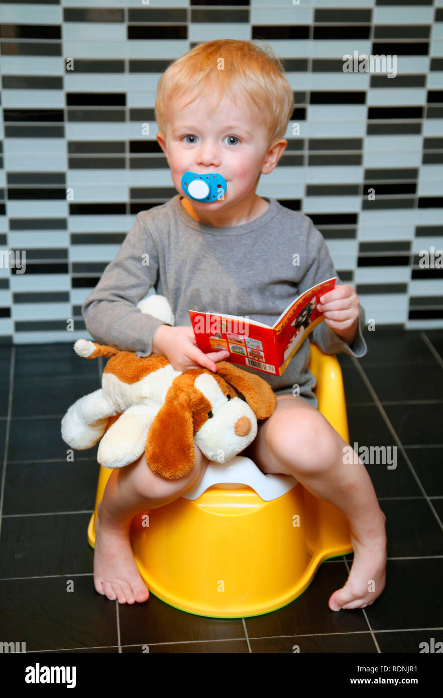 Junge sitzt auf dem Töpfchen Stockfoto
