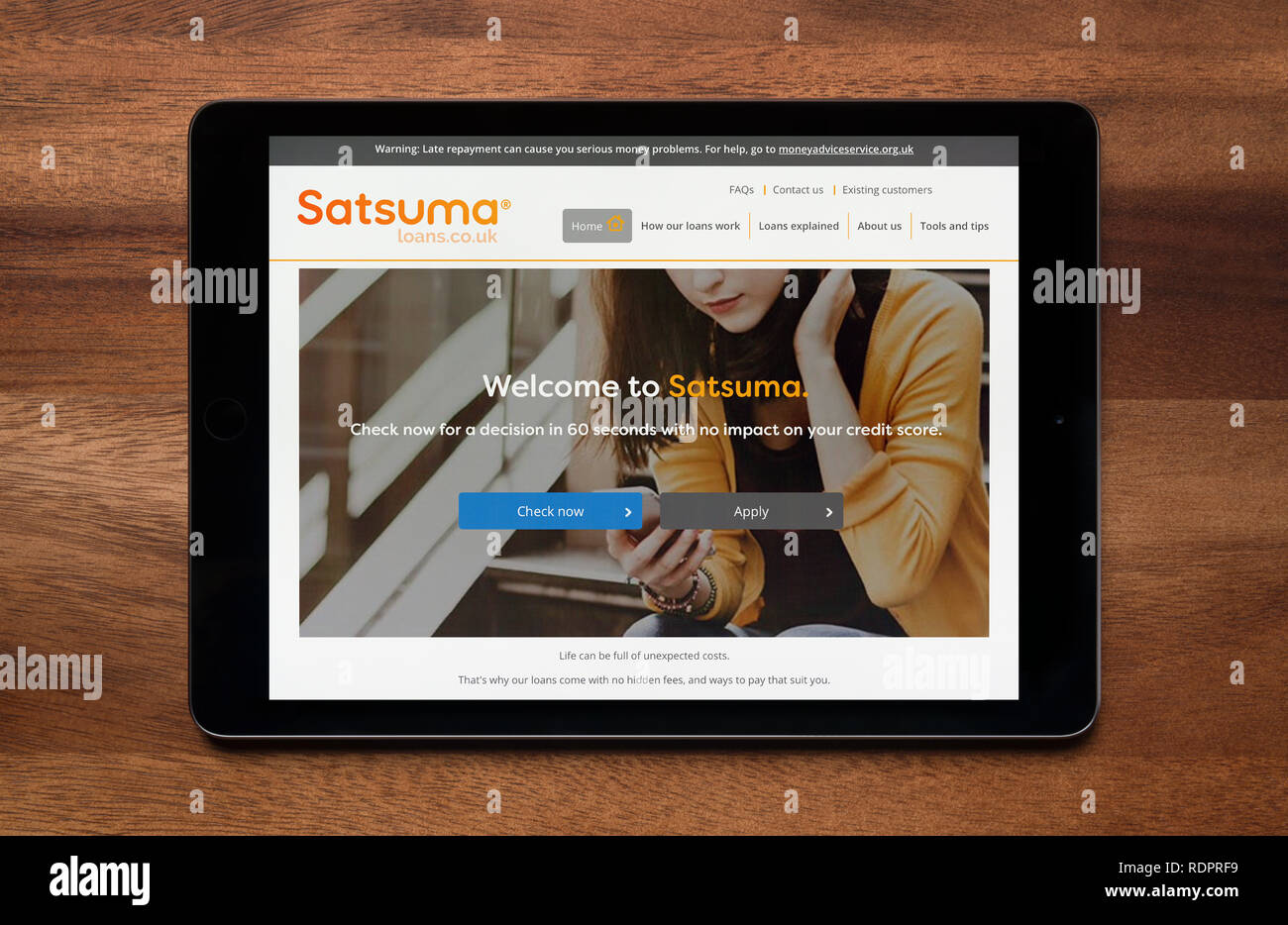 Die Website von Satsuma Darlehen ist gesehen auf einem iPad Tablet, der ruht auf einem Holztisch (nur redaktionelle Nutzung). Stockfoto