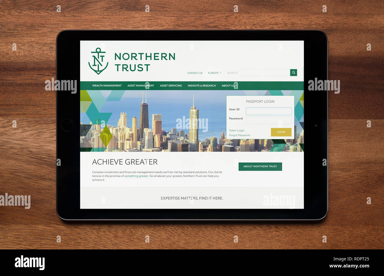 Die Website von Northern Trust wird gesehen, auf einem iPad Tablet, der ruht auf einem Holztisch (nur redaktionelle Nutzung). Stockfoto