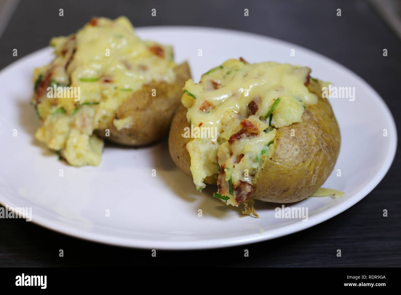 Eine Nahaufnahme von zwei gebackene Kartoffeln gefüllt mit Speck ...