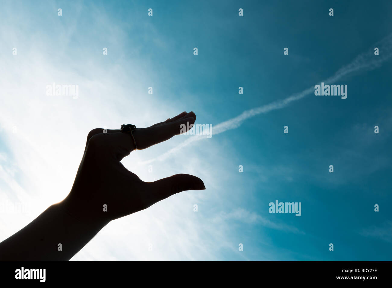 Menschliche Hand Silhouette am blauen Himmel Hintergrund Stockfoto