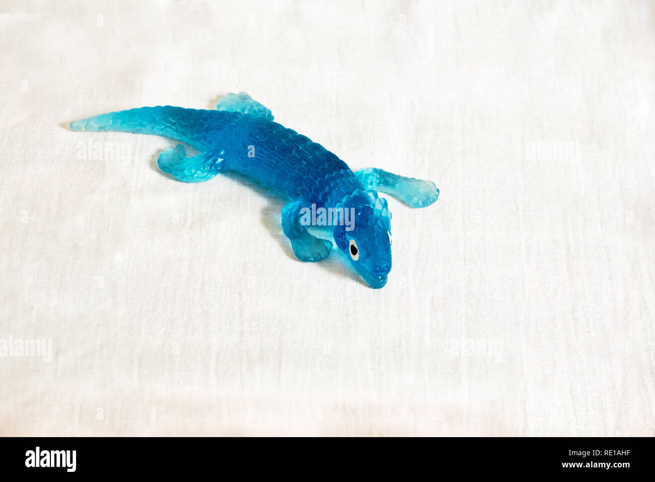 Dekorative blaue Eidechse aus weichem Jelly Material mit weißen Hintergrund isoliert. Stockfoto
