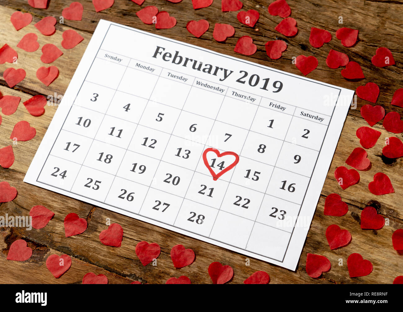 Kalender Seite mit roten Herzen am 14. Februar von Saint Valentines Tag auf vintage Tisch mit Herz in der romantischen Liebe Feier und Valentine' gerahmt Stockfoto