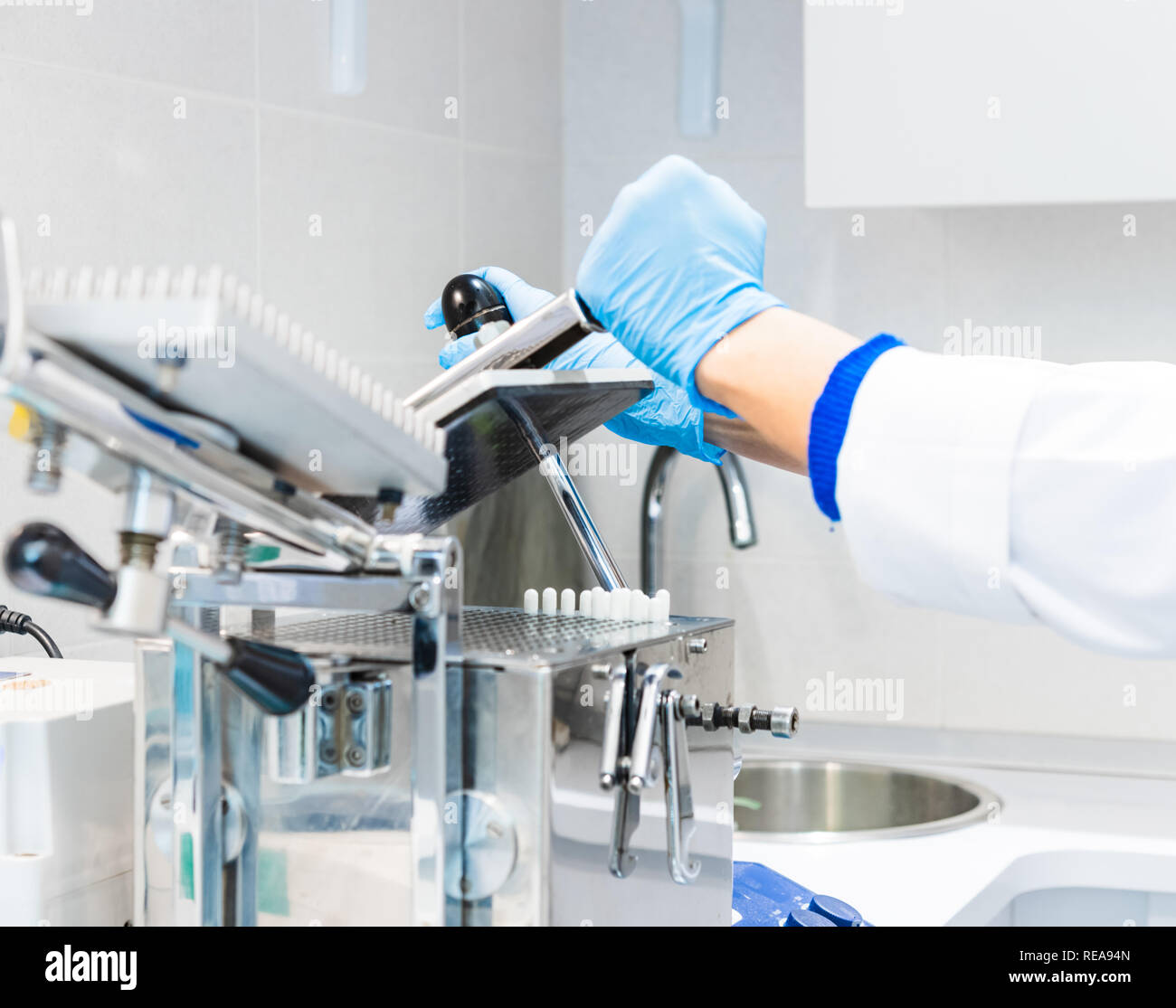 Nahaufnahme von menschlichen Händen mit Handschuh Handhabung encapsulator Maschine in Apotheke, Labor Stockfoto