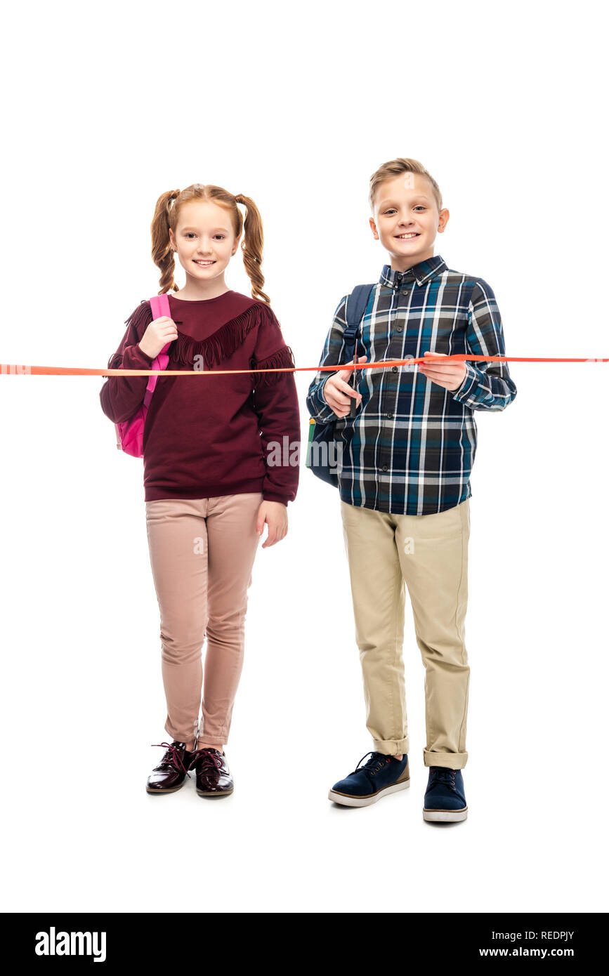 Lächelnd Schüler schneiden Red Ribbon und Kamera isoliert auf weißem Stockfoto