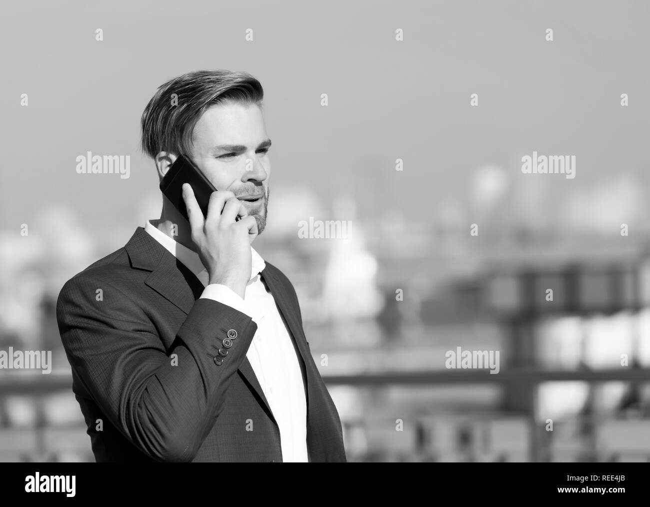 Manager mit Bart auf lächelnde Gesicht halten Sie Telefon. Business Communication und digitales Marketing. modernes Leben und neue Technologie. Mann in formalen Outfit mit Handy. Unternehmer oder Geschäftsführer urban fashion. Stockfoto