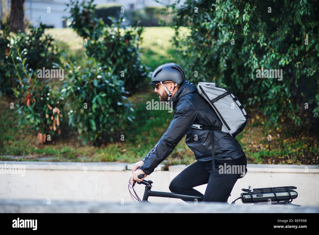 Männliche Fahrradkurier die Auslieferung von Paketen in der Stadt. Kopieren Sie Platz. Stockfoto