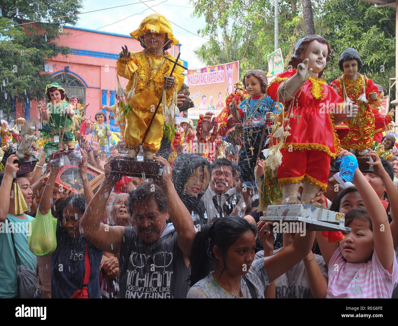 Die katholischen Gläubigen im heiligen Wasser getränkt mit Ihren Sto. Niños während des Fest der Sto. Niños in Tondo. Die katholischen Gläubigen bringen ihre Sto. Niños durch heiliges Wasser durch den Pfarrer von Tondo Kirche gesegnet werden zu feiern das Fest der "Santo Niño" (Kind Jesus). Stockfoto