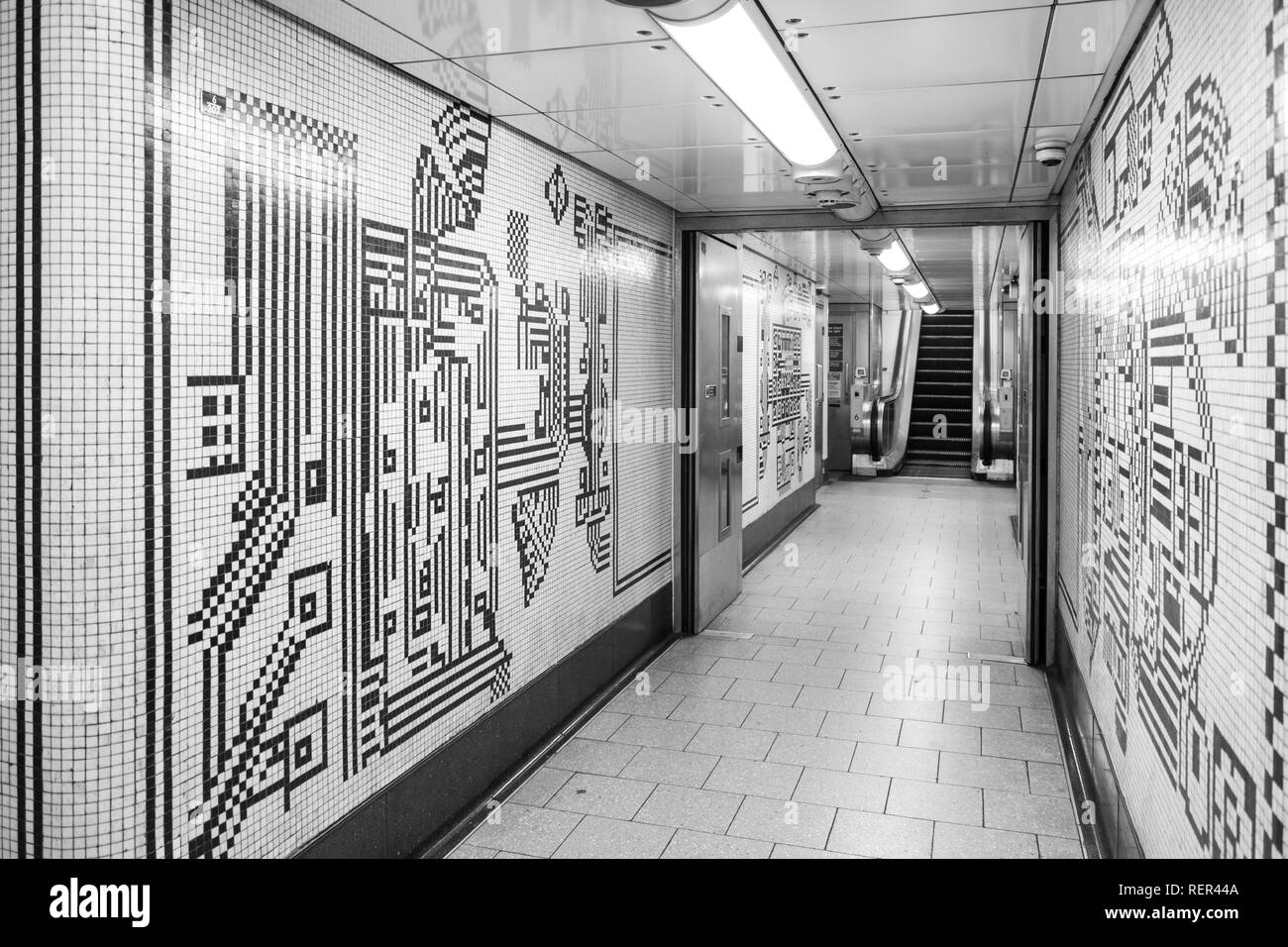 Der Tottenham Court Road U-Bahnstation, London, schwarzen und weißen Mosaikfliesen von Eduardo Paolozzi führende in die Northern Line Plattform. Stockfoto