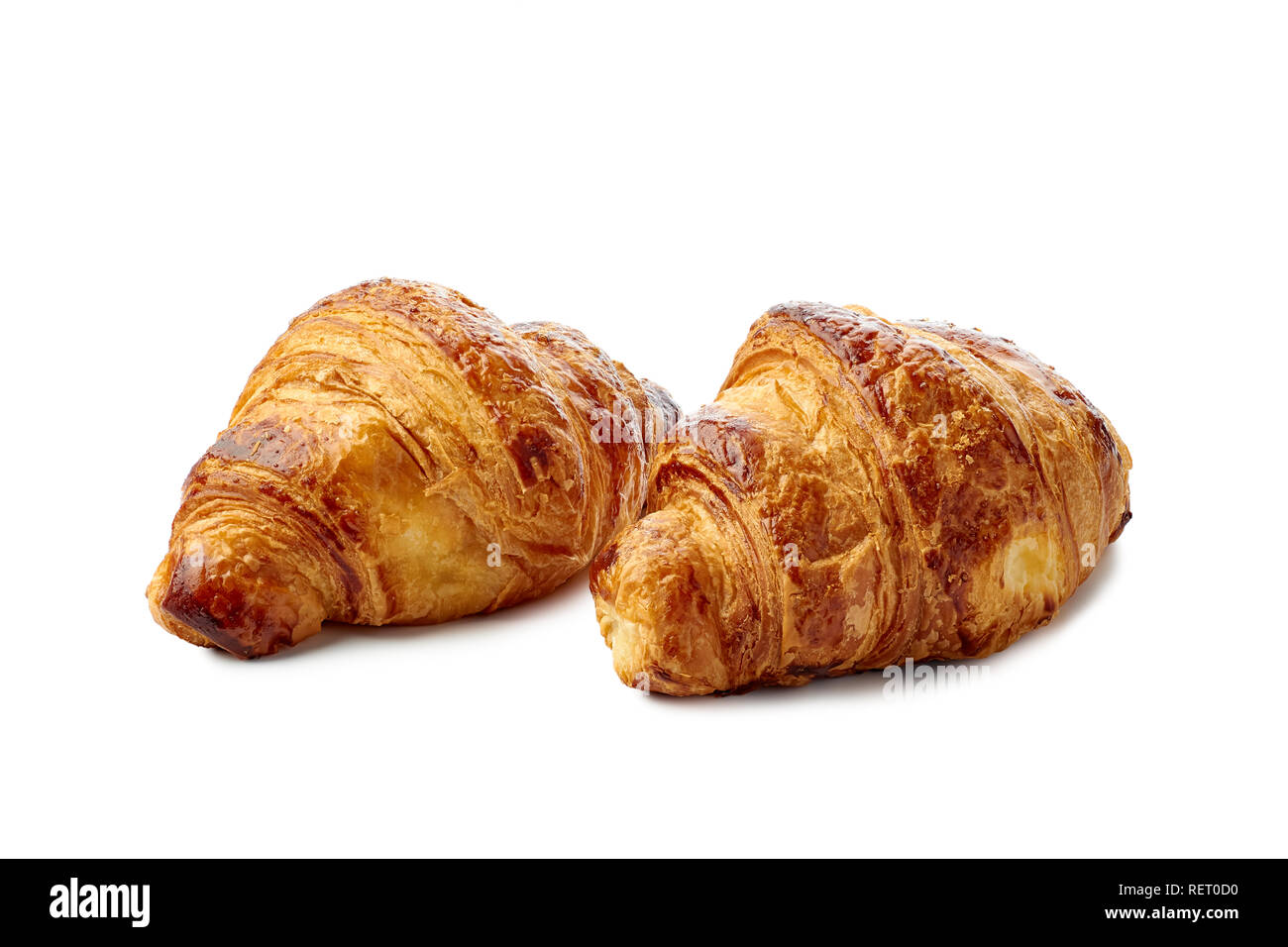 Zwei frische knusprige Croissants auf weißem Hintergrund Stockfoto