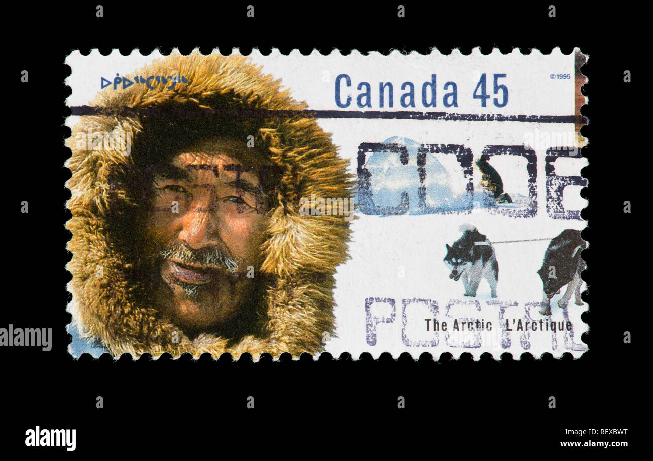 Briefmarke aus Kanada, ein Inuk Mann und Iglu. Stockfoto