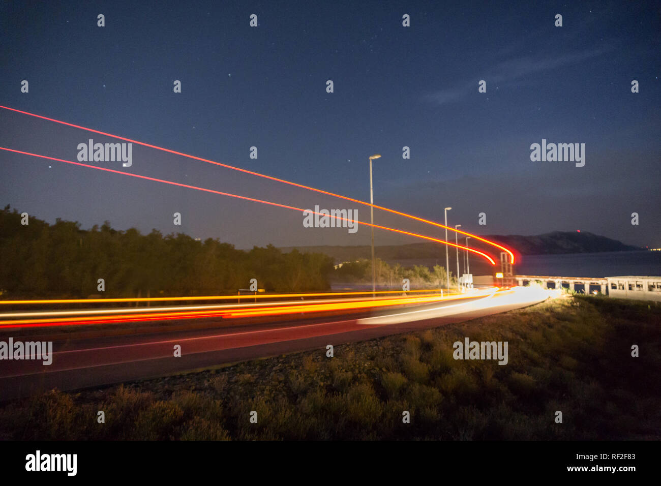 Lkw Licht im Tunnel. Kunst Bild. Lange Belichtung Foto auf einer Straße neben dem Meer Stockfoto